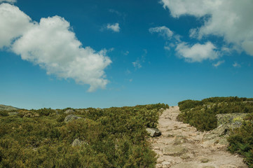 Trail passing through rocky terrain on highlands