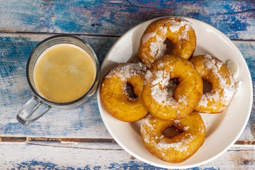 Fresh donuts with powdered sugar on the table