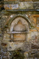 Carved stone within ruined wall