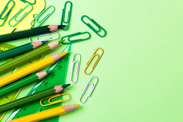 School supplies. Back to school concept on green background Top view Flat lay