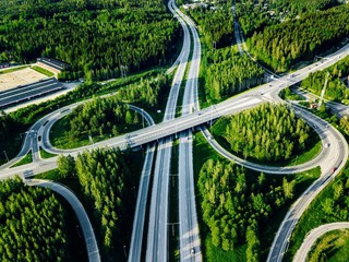 Plakat Aerial view of highway and overpass with green woods in Finland.