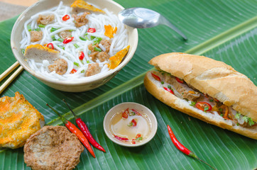 Banh Canh - Rice noodles soup with fried fish ball and Banh Mi Cha Ca - Vietnamese bread with fried fish and chili fish sauce inside. This is a typical combo for breakfast in south central of Vietnam