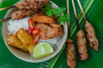Bun thit nuong - Vietnamese grilled pork and rice noodles: It is a mix of vermicelli noodles, grilled pork, spring rolls, eaten along with vegetable and sour and sweet fish sauce.