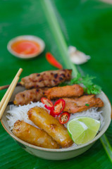 Bun thit nuong - Vietnamese grilled pork and rice noodles: It is a mix of vermicelli noodles, grilled pork, spring rolls, eaten along with vegetable and sour and sweet fish sauce.