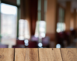vintage wooden table on blurred cafe background dining room restaurant
