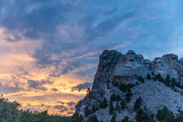 A dramatically colorful sky developing around sunset behind the four US presidents of Mount...