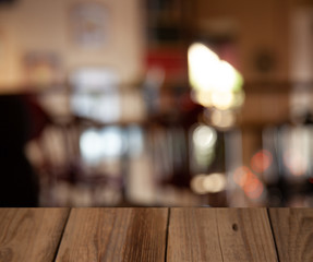 Naklejka na ściany i meble vintage wooden table on blurred cafe background dining room restaurant