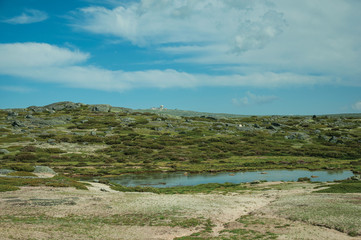 Lake on rocky landscape with domes of an old radar station