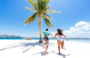 Couple spending time on a beutiful remote tropical island in the philippines. Concept about vacation and lifestyle.