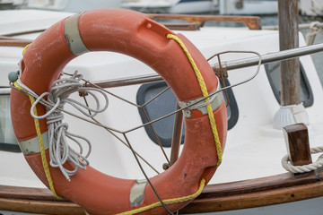 A lifebuoy, ring buoy, lifering, lifesaver, life donut, life preserver on the boat. Lifebuoy tied...