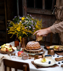 beautiful outdoor still life in country garden with bundt cake on wooden stand on rustic table