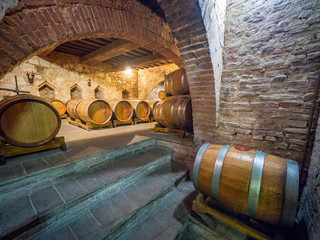 Oak barrels in an old underground wine cellar.