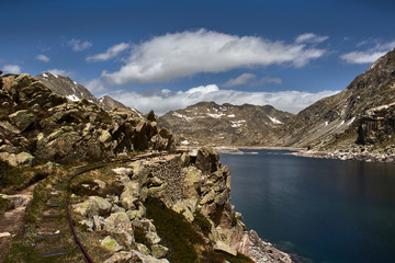 Naklejka na ściany i meble Pyrenean lake between rocky mountains