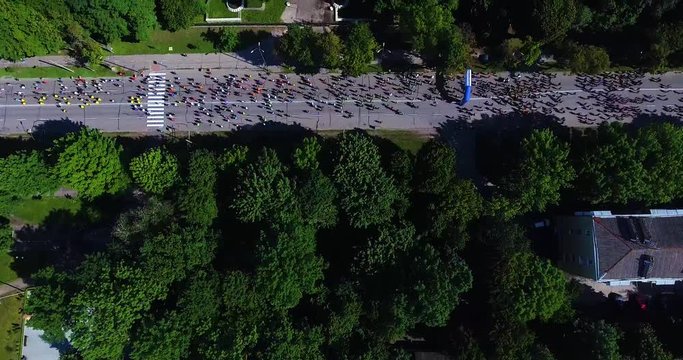 Aerial shot of marathon runners on asphalt road