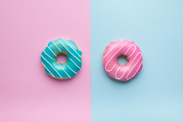 Blue and pink donuts on pink and blue background. 