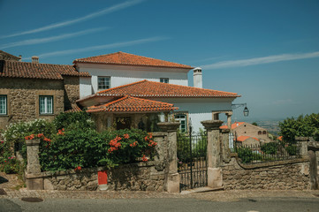 Obraz premium Charming old house with flowered bushes in Monsanto