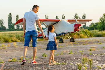 dad and 7 year old child playing plane