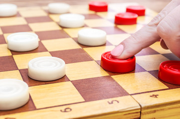 Woman playing checkers. Close up.