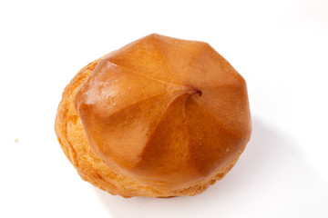 Profiterole or eclair, homemade sweets, close-up, isolated on white background.