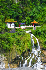Fototapeta na wymiar Changchun temple, landmark and a memorial shrine complex in Taroko National Park in Taiwan. The monument is located right above the beautiful waterfall streams. Tropical forest around. Rocks