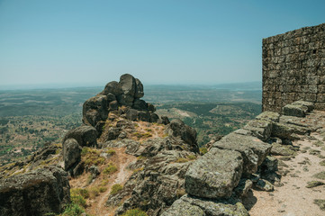 Stone wall on hilltop covered by rocks at the Castle of Monsanto
