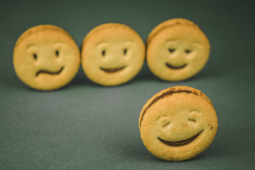 biscuit cookies with different emotions on a dark background