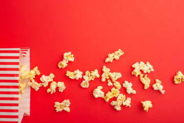 Paper packaging with popcorn on a colored background