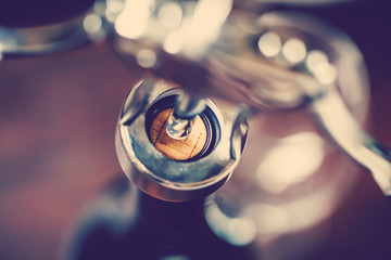 Wine bottle, cork and corkscrew detail with blurred background and vintage color tone effect