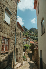 Fototapeta na wymiar Alley on slope with old stone houses at Monsanto