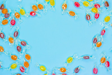 Pattern lollipops, candy on colorful white frame background, top view flat lay.