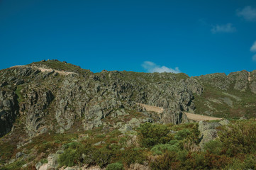 Fototapeta na wymiar Retaining wall of road passing through rocky landscape