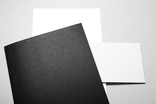 Blank Letterheads and Envelope over Black Folder