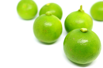 Closeup vibrant green limes isolated on white background