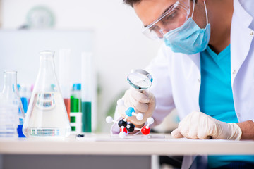 Young male chemist working in the lab 