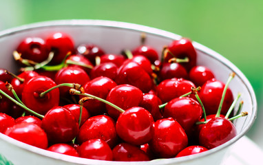 Fresh and beautiful red cherries in white dishes. Seasonal berries and healthy eating