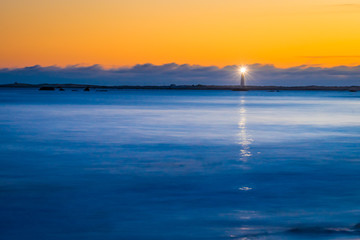 Fototapeta na wymiar Lighthouse ocean seascape coastline shoreline on Cape Sable Island, Nova Scotia.