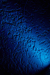 Against a background with an unusual pattern of diffused light of blue