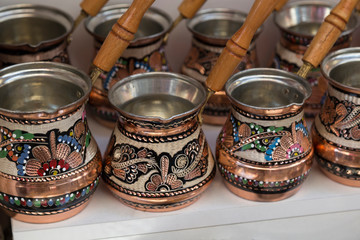 copper coffee pot  on the wooden background. old kitchenware for concept.