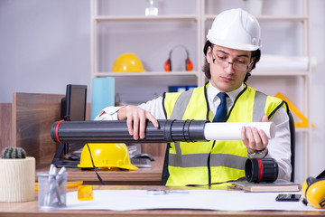 Young male architect working in the office 