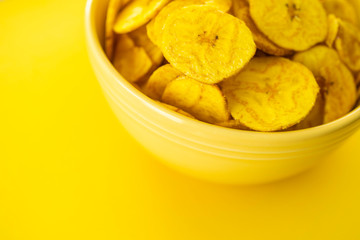 Baked Plantain Chips in Yellow bowl - a healthy snack