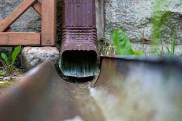 An old gutter in a detached house. Rainwater drainage from the roof.