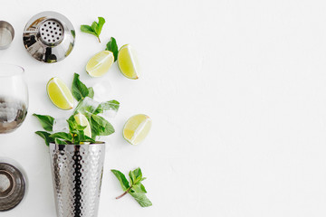 Bar accessories and ingredients for making mojito cocktail. Flat lay, top view. Summer drinks.