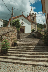 Church facade and steeple on top of stone staircase