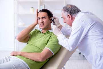 Male patient visiting doctor otolaryngologist