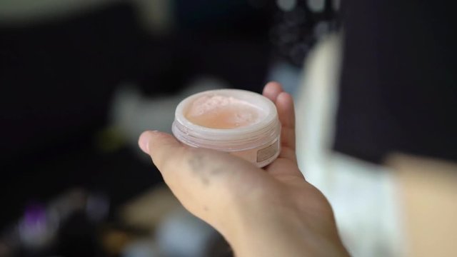 Woman with makeup brush and cosmetics