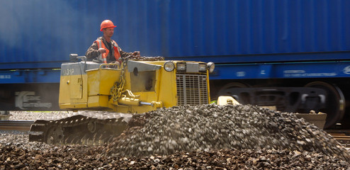 male operator driving excavator on construction building
