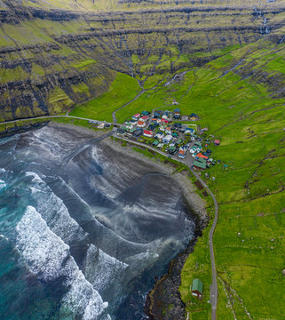 Tjornuvik village and beach and waterfalls aerial view, Faroe Islands