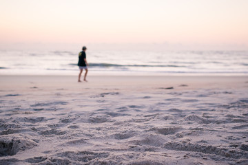 Blurred Person Walking the Beach Before Sunrise