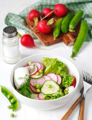 Spring vegetable salad with radish, cucumber and green peas