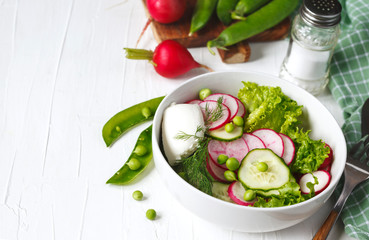 Spring vegetable salad with radish, cucumber and green peas